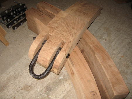 The shackle to anchor one end of the brakeshoe to the mill body