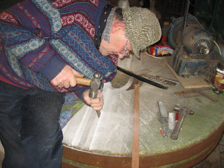 Michael dressing a millstone with hammer and chisel