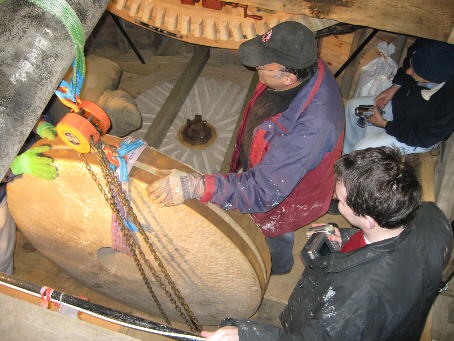 Runner stone being fitted above the bed stone