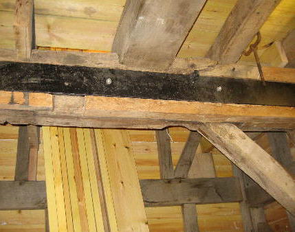 Steel plate bolted to old beam