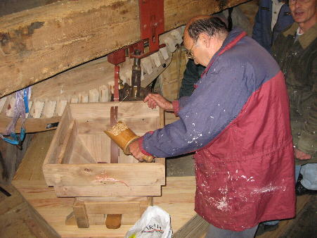 Danny putting the first wheat into hopper